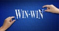 Win win word on Jigsaw puzzle. Man hand holding a blue puzzle to Royalty Free Stock Photo